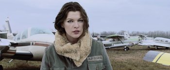 Movie still from “Resident Evil: Afterlife” (2010), directed by Paul W.S. Anderson – A woman in a military jacket and a fur collar; Medium shot, Low angle