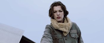 Movie still from “Resident Evil: Afterlife” (2010), directed by Paul W.S. Anderson – A woman in a shearling jacket and a fur scarf; Close Up shot, Low angle