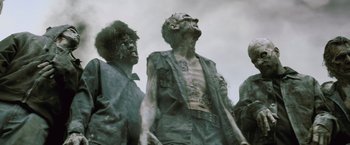 Movie still from “Resident Evil: Afterlife” (2010), directed by Paul W.S. Anderson – A group of zombies standing next to each other; Medium shot, Low angle