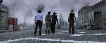 Movie still from “Resident Evil: Afterlife” (2010), directed by Paul W.S. Anderson – A group of men standing on top of a field; Wide shot, Low angle