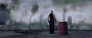 Movie still from “Resident Evil: Afterlife” (2010), directed by Paul W.S. Anderson – A man standing on top of a hill looking at the sky; Wide shot, Low angle
