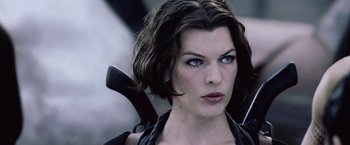 Movie still from “Resident Evil: Afterlife” (2010), directed by Paul W.S. Anderson – A person holding a gun; Close Up shot, Low angle