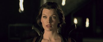 Movie still from “Resident Evil: Afterlife” (2010), directed by Paul W.S. Anderson – A person with short brown hair; Close Up shot, Over the shoulder angle
