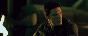 Movie still from “Resident Evil: Afterlife” (2010), directed by Paul W.S. Anderson – A person sitting in a room; Close Up shot, Over the shoulder angle