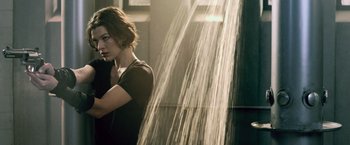 Movie still from “Resident Evil: Afterlife” (2010), directed by Paul W.S. Anderson – A woman standing in front of a water fountain; Medium shot, Low angle