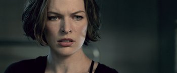 Movie still from “Resident Evil: Afterlife” (2010), directed by Paul W.S. Anderson – A person with short black hair; Close Up shot, Over the shoulder angle