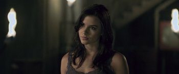 Movie still from “Resident Evil: Afterlife” (2010), directed by Paul W.S. Anderson – A beautiful young woman with long dark hair; Close Up shot, Over the shoulder angle