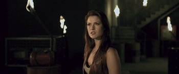 Movie still from “Resident Evil: Afterlife” (2010), directed by Paul W.S. Anderson – A beautiful young woman standing in a dark room; Close Up shot, Over the shoulder angle