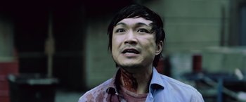 Movie still from “Resident Evil: Afterlife” (2010), directed by Paul W.S. Anderson – A man with blood on his face is looking up; Close Up shot, Low angle