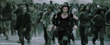 Movie still from “Resident Evil: Afterlife” (2010), directed by Paul W.S. Anderson – A group of people walking through a field; Wide shot, High angle