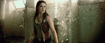 Movie still from “Resident Evil: Afterlife” (2010), directed by Paul W.S. Anderson – A woman standing in front of a wall of water; Medium shot, Over the shoulder angle
