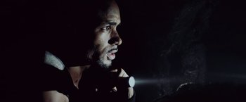 Movie still from “Resident Evil: Afterlife” (2010), directed by Paul W.S. Anderson – A person holding a flashlight in the dark; Close Up shot, Low angle
