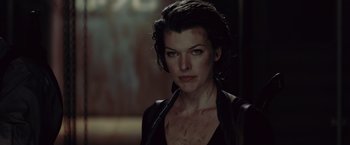 Movie still from “Resident Evil: Afterlife” (2010), directed by Paul W.S. Anderson – A person wearing a black shirt; Close Up shot, Over the shoulder angle