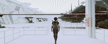 Movie still from “Resident Evil: Afterlife” (2010), directed by Paul W.S. Anderson – A man walking across a bridge in front of a bunch of planes; Wide shot, Low angle