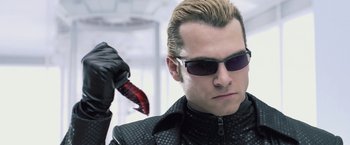 Movie still from “Resident Evil: Afterlife” (2010), directed by Paul W.S. Anderson – A person wearing sunglasses and a leather jacket; Close Up shot, Low angle
