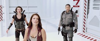 Movie still from “Resident Evil: Afterlife” (2010), directed by Paul W.S. Anderson – A man and a woman are standing in a room; Medium shot, Low angle