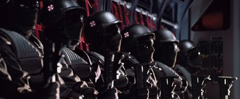 Movie still from “Resident Evil: Afterlife” (2010), directed by Paul W.S. Anderson – A group of people wearing helmets and holding guns; Medium shot, Low angle