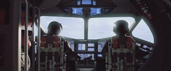 Movie still from “Resident Evil: Afterlife” (2010), directed by Paul W.S. Anderson – Two pilots are in the cockpit of an airplane; Wide shot, Low angle