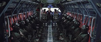 Movie still from “Resident Evil: Afterlife” (2010), directed by Paul W.S. Anderson – A woman standing in the middle of an airplane; Wide shot, High angle