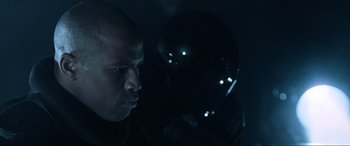 Movie still from “Resident Evil: Apocalypse” (2004), directed by Alexander Witt – A man with a bald head looking into a mirror; Close Up shot, Over the shoulder angle
