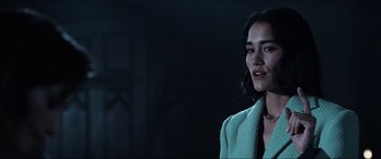 Movie still from “Resident Evil: Apocalypse” (2004), directed by Alexander Witt – A woman in a green jacket standing in a room; Close Up shot, Low angle