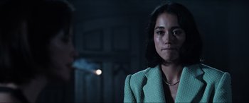 Movie still from “Resident Evil: Apocalypse” (2004), directed by Alexander Witt – A woman in a green jacket is looking at the camera; Close Up shot, Over the shoulder angle