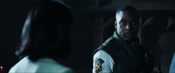 Movie still from “Resident Evil: Apocalypse” (2004), directed by Alexander Witt – A person wearing a uniform; Close Up shot, Over the shoulder angle