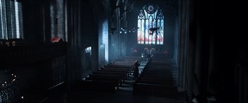 Movie still from “Resident Evil: Apocalypse” (2004), directed by Alexander Witt – A church with pews in front of a stained glass window; Extreme Wide shot, High angle