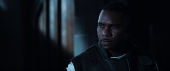 Movie still from “Resident Evil: Apocalypse” (2004), directed by Alexander Witt – A person wearing a vest; Close Up shot, Over the shoulder angle