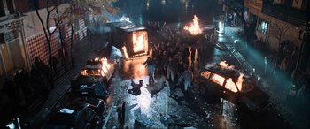 Movie still from “Resident Evil: Apocalypse” (2004), directed by Alexander Witt – A group of people standing next to a fire pit; Extreme Wide shot, High angle