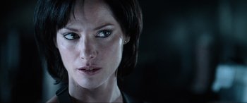 Movie still from “Resident Evil: Apocalypse” (2004), directed by Alexander Witt – A woman's face in a dark room; Close Up shot, Over the shoulder angle