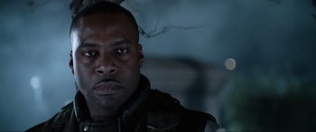 Movie still from “Resident Evil: Apocalypse” (2004), directed by Alexander Witt – A person wearing a black jacket; Close Up shot, Low angle