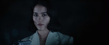 Movie still from “Resident Evil: Apocalypse” (2004), directed by Alexander Witt – A person wearing a suit; Close Up shot, Low angle