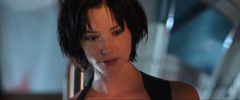 Movie still from “Resident Evil: Apocalypse” (2004), directed by Alexander Witt – A person with short black hair; Close Up shot, Low angle