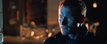 Movie still from “Resident Evil: Apocalypse” (2004), directed by Alexander Witt – A person wearing a black jacket; Close Up shot, Over the shoulder angle