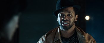 Movie still from “Resident Evil: Apocalypse” (2004), directed by Alexander Witt – A person wearing a hat and a leather jacket; Close Up shot, Low angle