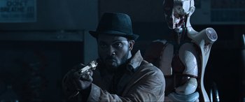 Movie still from “Resident Evil: Apocalypse” (2004), directed by Alexander Witt – A man in a hat is holding something in his mouth; Close Up shot, Low angle