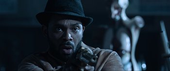 Movie still from “Resident Evil: Apocalypse” (2004), directed by Alexander Witt – A man holding a gun in his hand; Close Up shot, Over the shoulder angle