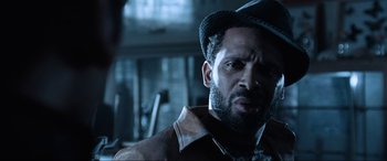 Movie still from “Resident Evil: Apocalypse” (2004), directed by Alexander Witt – A person wearing a hat and a jacket; Close Up shot, Over the shoulder angle