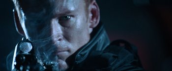 Movie still from “Resident Evil: Apocalypse” (2004), directed by Alexander Witt – A man's face in a black jacket; Close Up shot, Low angle