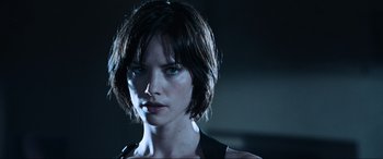 Movie still from “Resident Evil: Apocalypse” (2004), directed by Alexander Witt – A person with short brown hair; Close Up shot, Low angle
