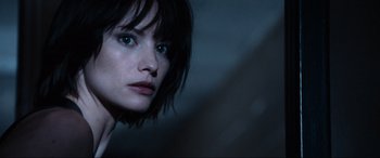 Movie still from “Resident Evil: Apocalypse” (2004), directed by Alexander Witt – A person with short black hair; Close Up shot, Low angle