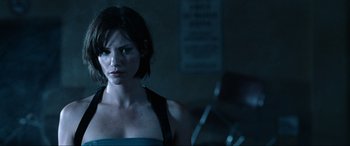 Movie still from “Resident Evil: Apocalypse” (2004), directed by Alexander Witt – A person with short black hair; Close Up shot, Over the shoulder angle