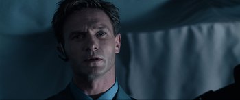 Movie still from “Resident Evil: Apocalypse” (2004), directed by Alexander Witt – A person wearing a suit and tie; Close Up shot, Low angle