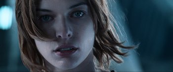 Movie still from “Resident Evil: Apocalypse” (2004), directed by Alexander Witt – A woman's face with long brown hair; Close Up shot, Low angle