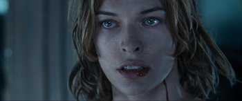 Movie still from “Resident Evil: Apocalypse” (2004), directed by Alexander Witt – A woman's face with blood dripping from her mouth; Close Up shot, Over the shoulder angle