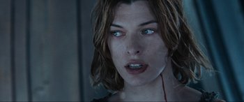 Movie still from “Resident Evil: Apocalypse” (2004), directed by Alexander Witt – A person with blood on their face; Close Up shot, Over the shoulder angle