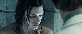 Movie still from “Resident Evil: Apocalypse” (2004), directed by Alexander Witt – A woman with wet hair is looking down at her face; Close Up shot, Low angle