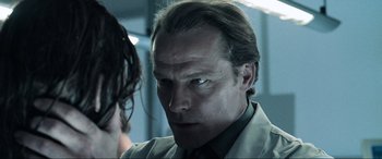 Movie still from “Resident Evil: Apocalypse” (2004), directed by Alexander Witt – A person wearing a suit and tie; Close Up shot, Low angle