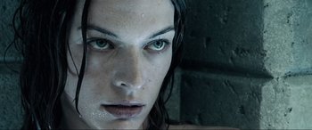 Movie still from “Resident Evil: Apocalypse” (2004), directed by Alexander Witt – A woman's face with wet hair; Close Up shot, Low angle